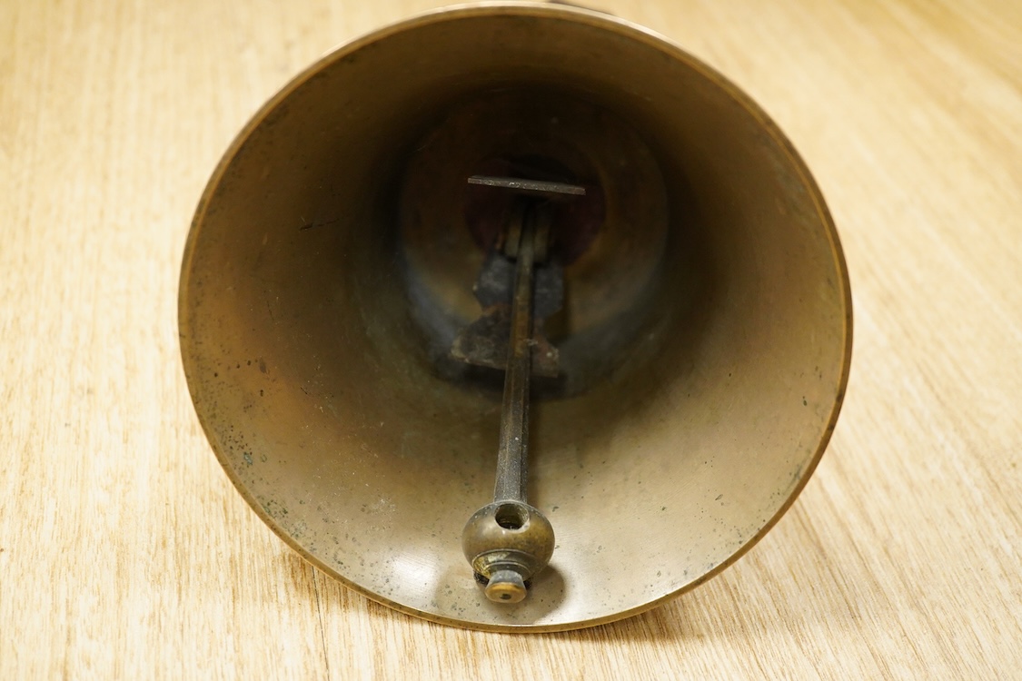 A set of twenty-two bronze handbells by Mears, London, with leather grips, together with two books from the Jasper Snowden Change Ringing Series, largest diameter 16cm